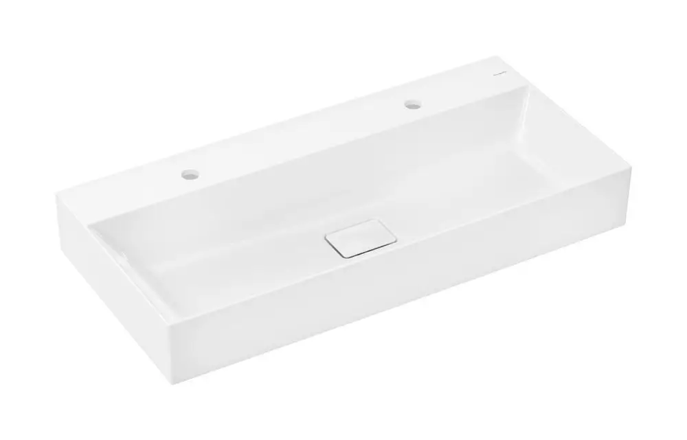 Weißer Waschtisch von Hansgrohe mit rechteckiger Form, zwei Hahnlöchern. Es gibt keinen Überlauf. Oberfläche ist glatt und einfach gestaltet.